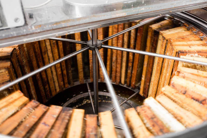 A centrifugal honey extractor in action.