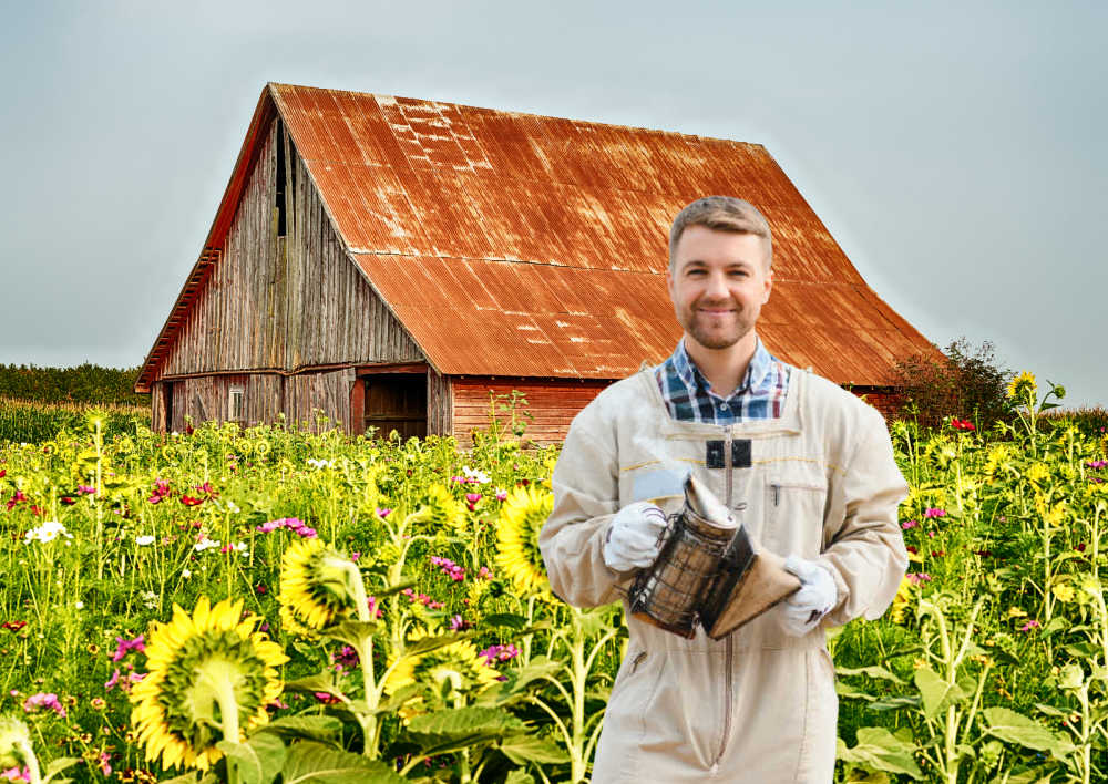A beekeeper wearing protective clothing with a field of flowers in the background